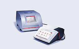 Anton Paar Monowave 400 R microwave synthesis reactor (left) and Cora 5001 Raman spectrometer (right) shown together. The Monowave 400 R features a touchscreen interface for reaction control, while the Cora 5001 provides molecular spectroscopy analysis in real-time.