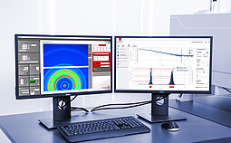 Dual-monitor setup with SAXSanalysis Pro software displaying scattering curves, size distribution analysis, and detector control interface.